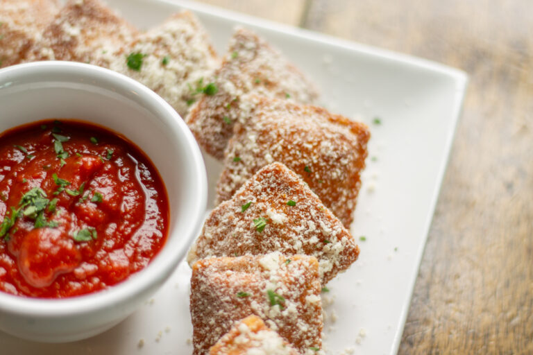 Fried Ravioli appetizer with homemade Nonna's gravy red tomato sauce at PARMED restaurant inside Liberty Hound in Buffalo NY